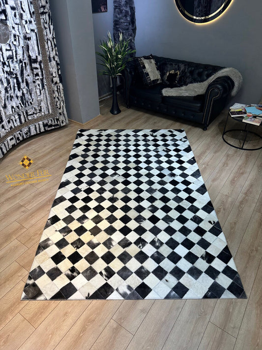 Handmade checkers black and white genuine cowhide leather 6x8 area rug on wooden floor in living room