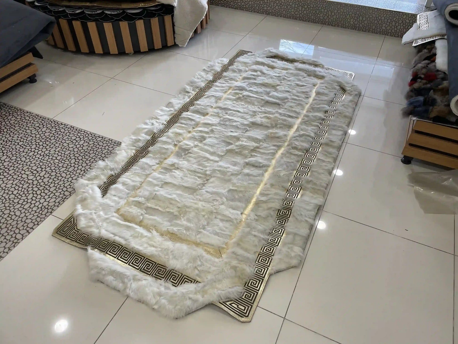 Soft fluffy white gold genuine sheepskin handmade corridor rug on tiled floor