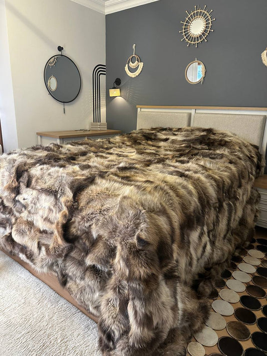 Handmade natural raccoon fur bedspread on bed in modern bedroom interior