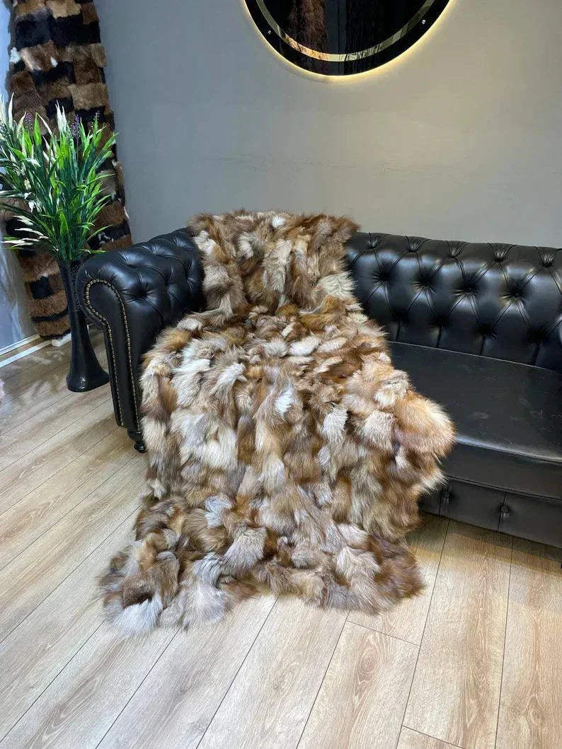Unique Colour 100 Natural Fox Fur Blanket draped on black leather sofa, showcasing handmade luxury bed cover with soft, multicolored natural fox fur texture.