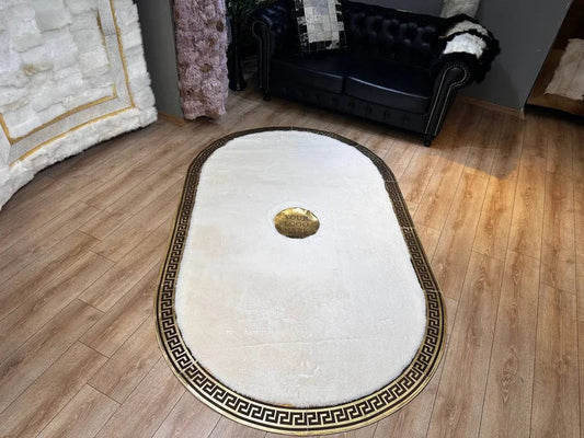 White oval faux fur rug with gold Greek key pattern in a living room setting
