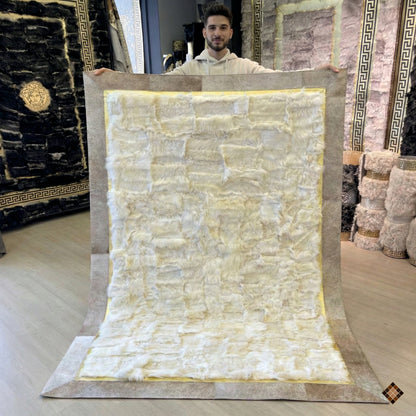 Transform your home with our handmade white sheepskin rug featuring a stunning gold and natural hide border. Custom-made luxury for your ultimate comfort.