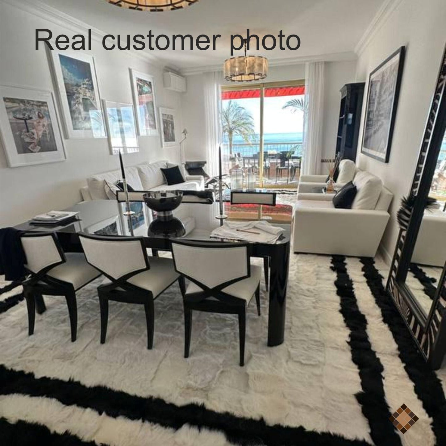 Black and white natural sheepskin rug with soft ivory center and bold black border in modern living room