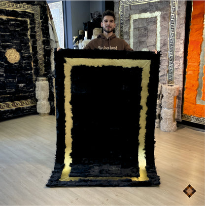 Elevate your space with a handmade black sheepskin rug framed in gold. Custom sizes available for a bold, luxurious feel underfoot.