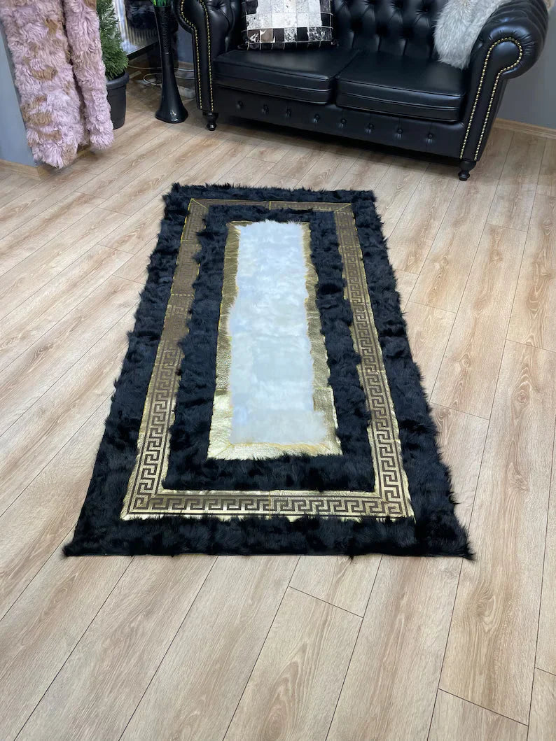 Black white natural sheepskin area rug with gold pattern on wooden floor in living room